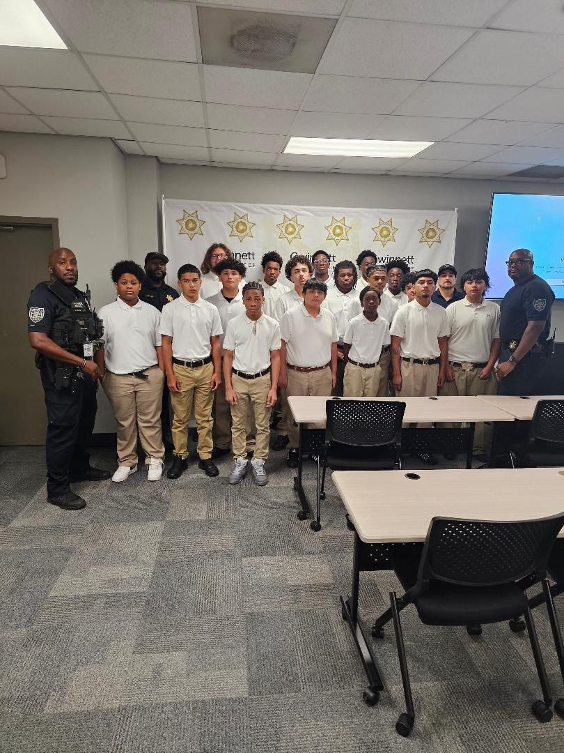 STRAP participants with law-enforcement personnel during a classroom session.